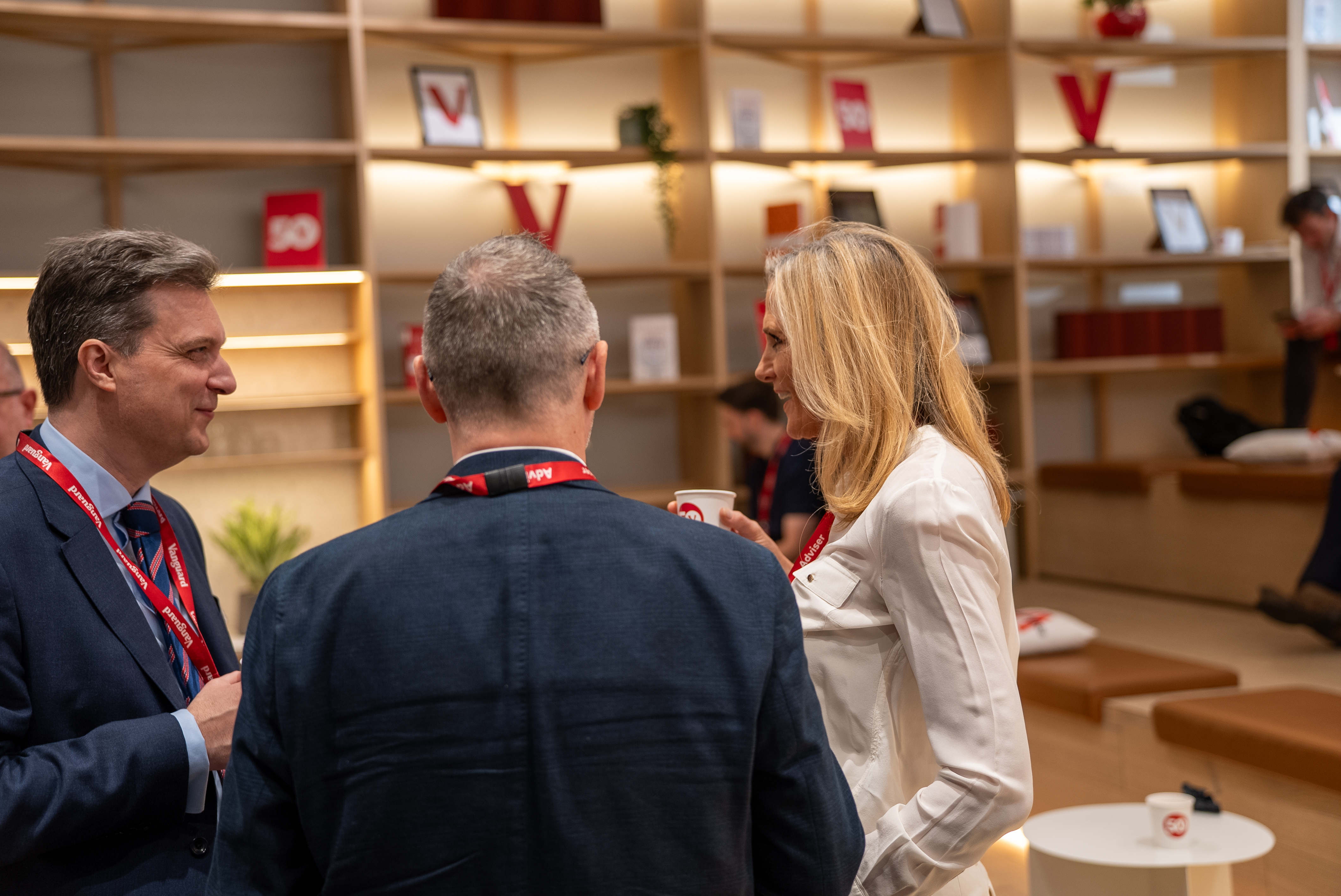 Three conference attendees chatting during a break